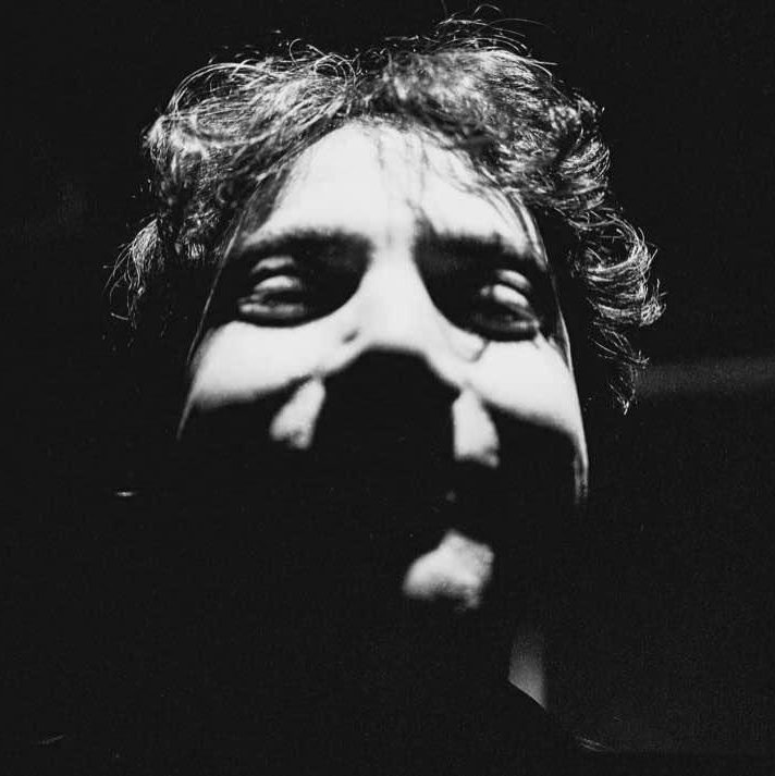 An image of a man's face in shadows.